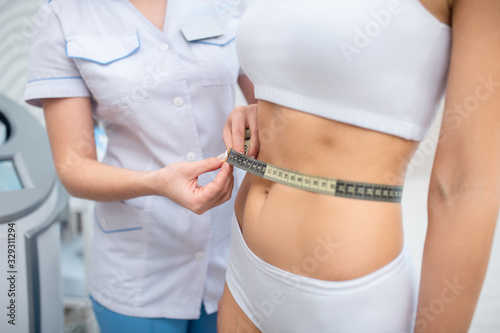 Slim woman wearing underwear coming to nutrition specialist © zinkevych