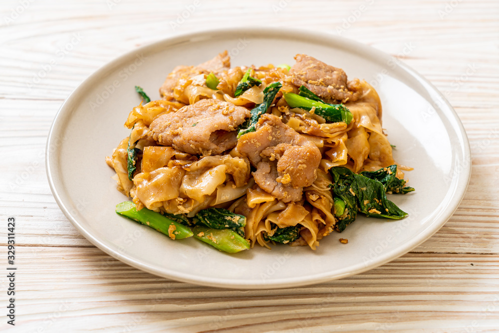 Stir-fried rice noodle with black soy sauce and pork and kale Stir-fried rice noodle with black soy sauce and pork and kale
