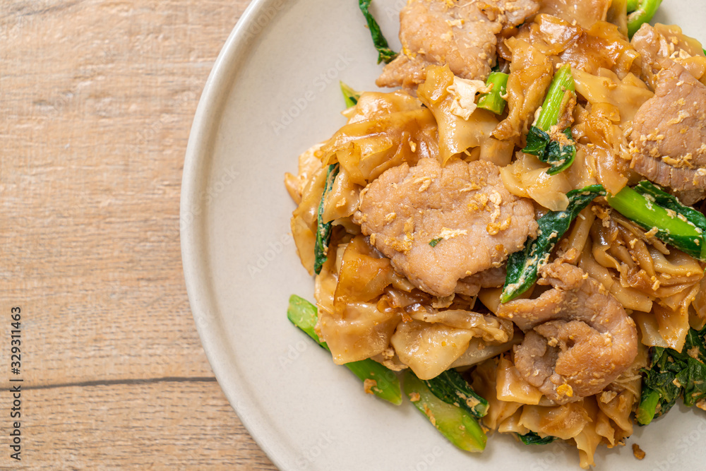 Stir-fried rice noodle with black soy sauce and pork and kale Stir-fried rice noodle with black soy sauce and pork and kale