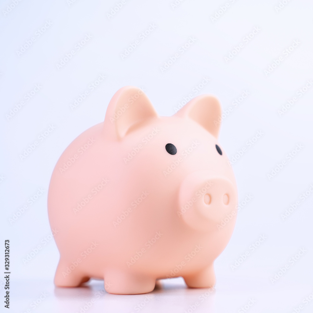 Financial concpet - Piggy bank, beautiful red white wooden house model on white background, saving money to buy insurance, close up, copy space.