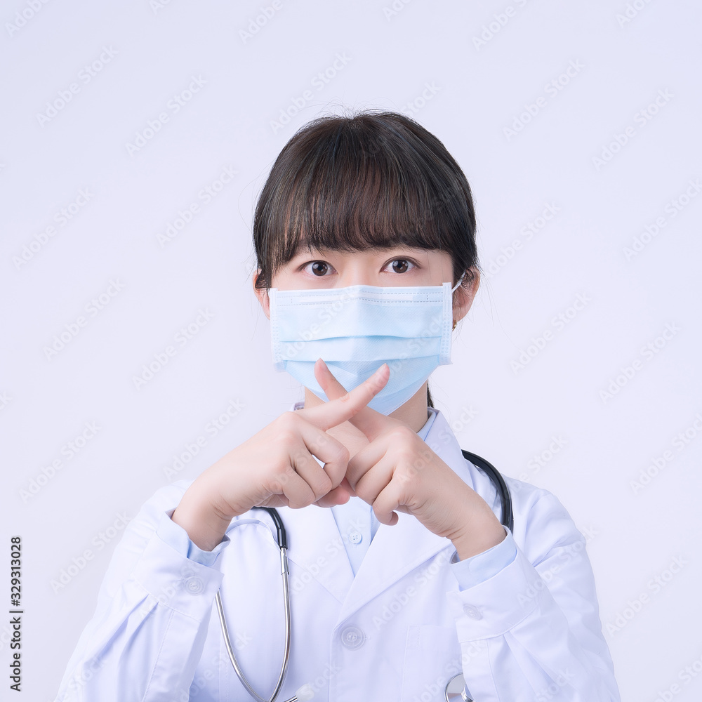 Young female doctor woman wearing mask, making stop sign gesture, saysignaling No isolated on white background, refusing virus disease, close up, blank. Young female doctor woman wearing mask, making stop sign gesture, saysignaling No isolated on white background, refusing virus disease, close up, blank.