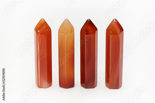 Obraz na plátně Four natural raw mineral crystal cornelian close-up isolated on white background