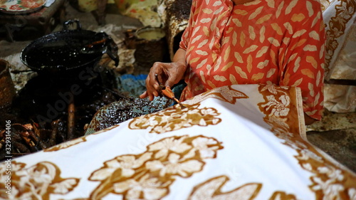 Blurred image out of focus Activity of making batik, Create and design white fabric using canting and malam by slamming over the fabric, 