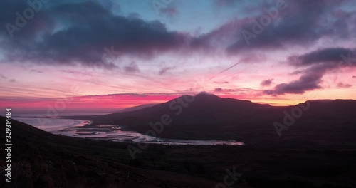 Breathtaking and spectacular 4K video of sunrise in Brandon Bay with moving clouds and fiery colors, Dingle Peninsula, Ireland