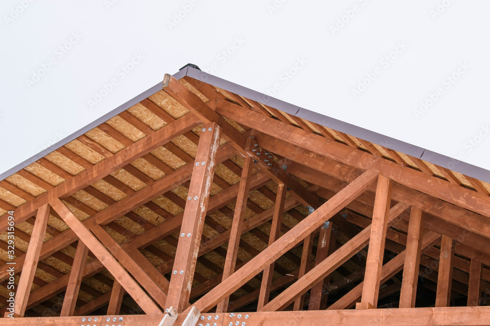 System of a pitched roof without a crossbar. Vertical rack, inclined struts, rafters and lathing. Low-rise construction concept. System of a pitched roof without a crossbar. Vertical rack, inclined struts, rafters and lathing. Low-rise construction concept.