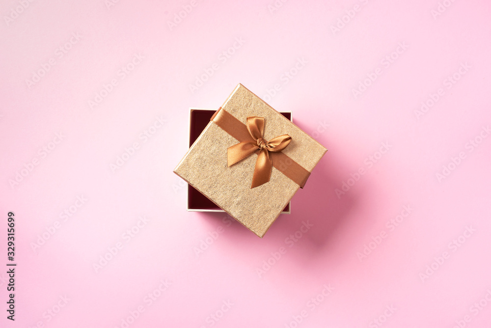 Valentine's Day. Golden gift box on pink background. Top view. Copy space. Festive backdrop for holidays: Birthday, Valentines day, Christmas, New Year. Flat lay style. Banner Valentine's Day. Golden gift box on pink background. Top view. Copy space. Festive backdrop for holidays: Birthday, Valentines day, Christmas, New Year. Flat lay style. Banner