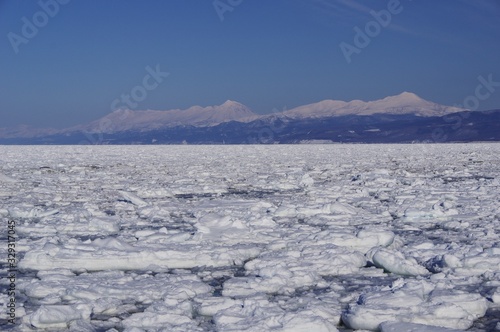 Shiretoko, winter landscape with mountain range and ice floe in Hokkaido, Japan 流氷と冬の知床連山 北海道