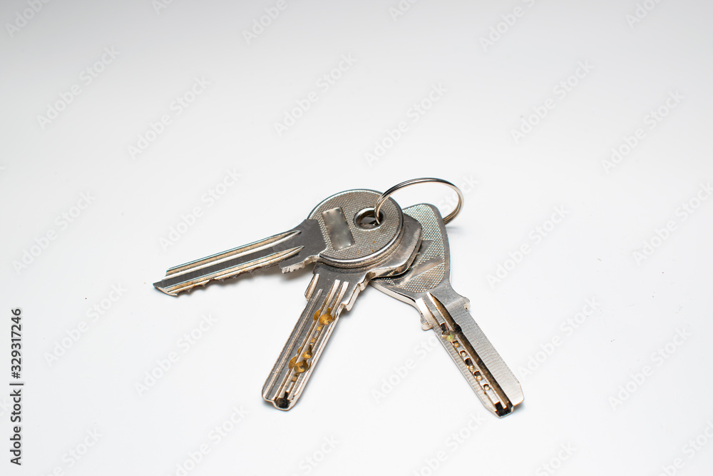 Keys on a key chain. Keys used for opening doors seen from above, on a background. Keys on a key chain. Keys used for opening doors seen from above, on a background.