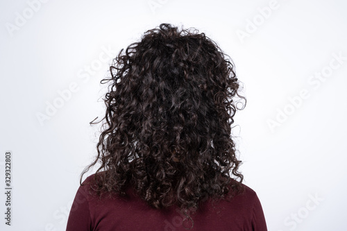 A brunette with modern and fashion curly hairstyle and long black hairs