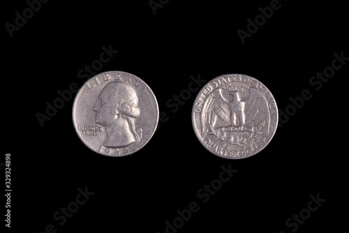 Fotografi American quarter of a coin, 1966. Black background.