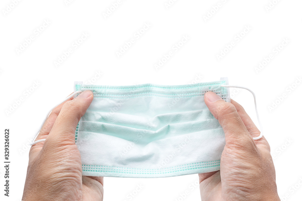 Hand holding Hygienic mask or surgical earloop face mask isolated on white background with clipping path. anti virus and bacteria protective face air pollution, environmental and protection concept. Hand holding Hygienic mask or surgical earloop face mask isolated on white background with clipping path. anti virus and bacteria protective face air pollution, environmental and protection concept.