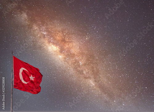 Turkish flag on the mast over milky way.