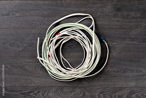 simple white wire cord flat lay on the colorful background isolated, network connection industry