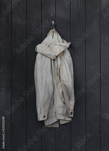 old worn jacket on a hanger
