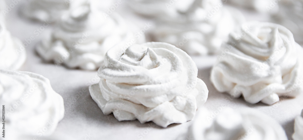on a white pastel background lies a fresh white handmade marshmallow