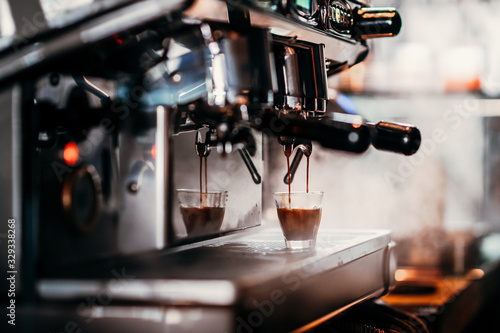 close-up image of the coffee machines that are operating automatical Coffee flowing into coffee cup that is prepar for service Coffee aroma bake the whole shop and the shop atmosphere that look warm