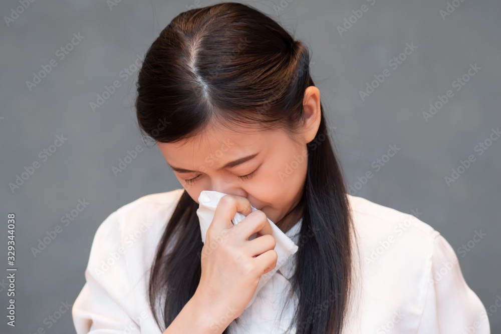 sick woman having runny nose due to virus outbreak; concept of biohazard, biological hazard, preventive health care, disease quarantine, coronavirus outbreak control, sickness containment, COVID-19 sick woman having runny nose due to virus outbreak; concept of biohazard, biological hazard, preventive health care, disease quarantine, coronavirus outbreak control, sickness containment, COVID-19