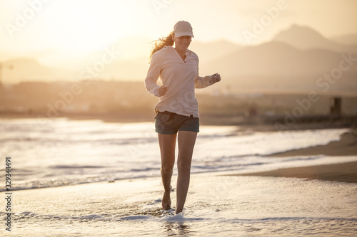 Young woman running on the La Tejita beach