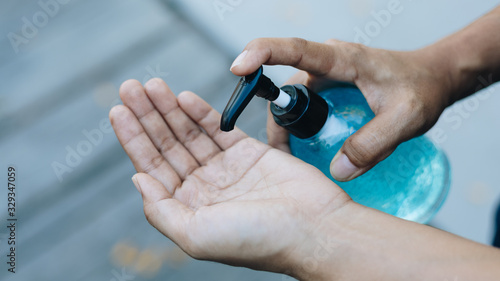 Close Up People using alcohol gel to wash hands to prevent viruses and diseases.
