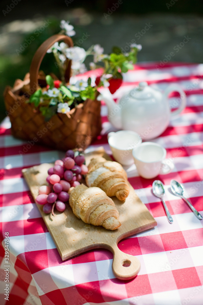 Tasty croissants with grape on the wooden desk