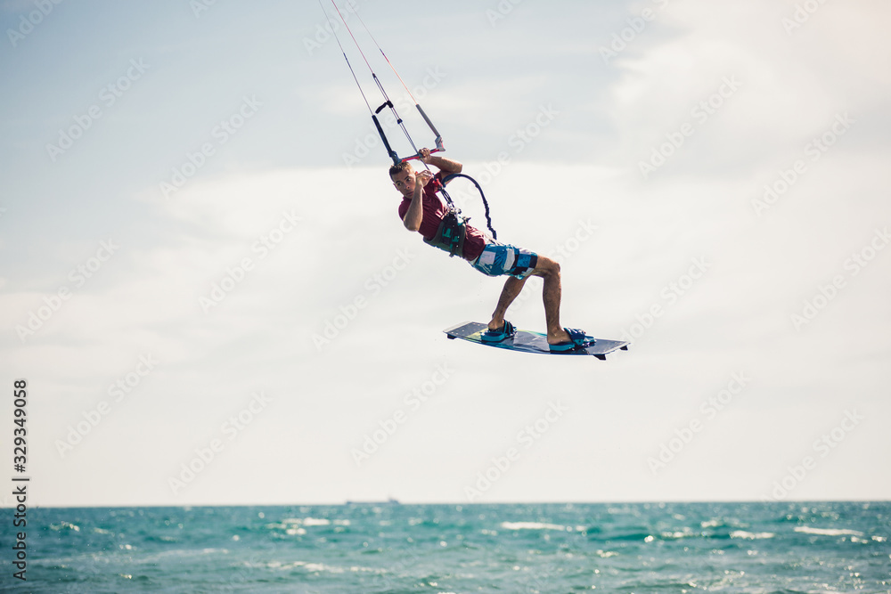 Professional kiter makes the difficult trick on a beautiful background. Kitesurfing Kiteboarding action photos man among waves quickly goes Professional kiter makes the difficult trick on a beautiful background. Kitesurfing Kiteboarding action photos man among waves quickly goes