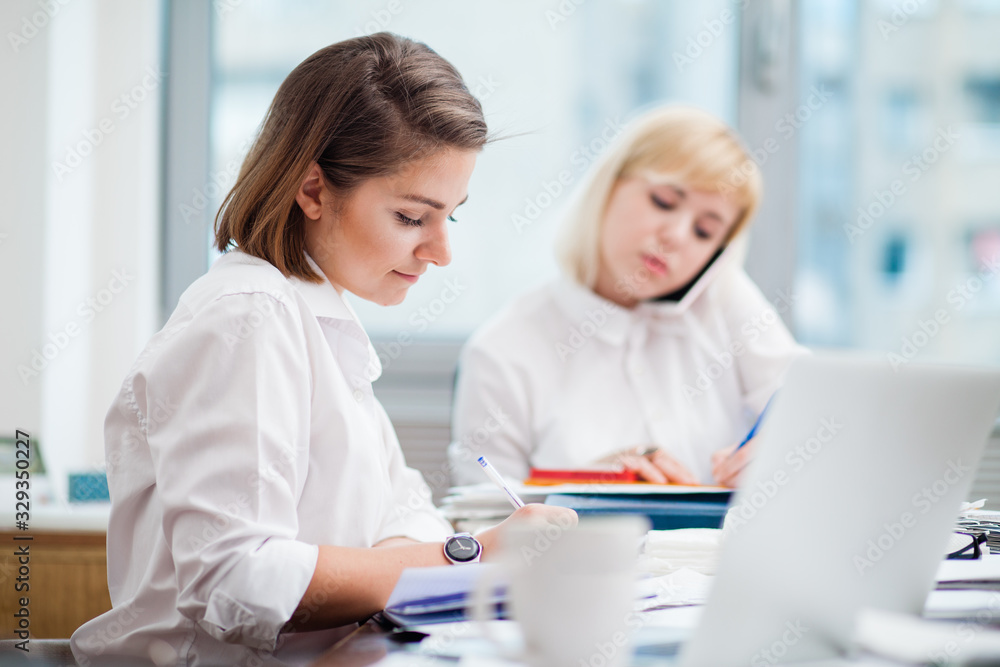Two women working in an office Two women working in an office