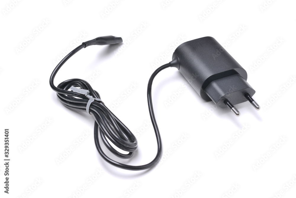 Charger for gadgets in black with cable and connector, isolated on a white background with a shadow Charger for gadgets in black with cable and connector, isolated on a white background with a shadow