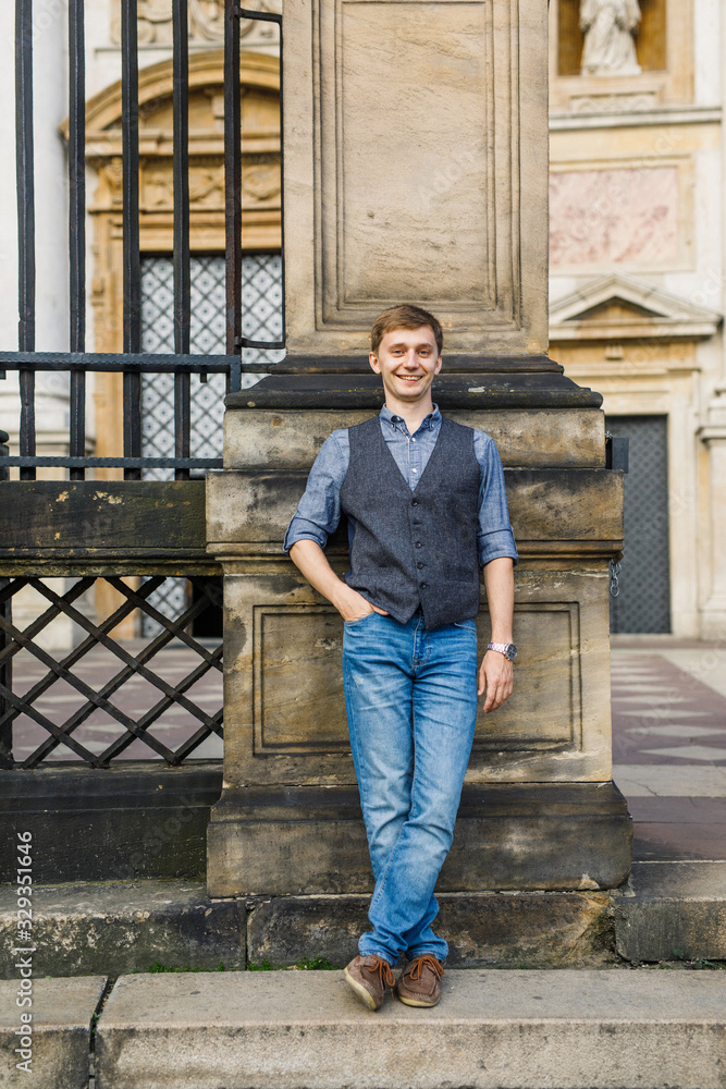 portrait of a man in a blue shirt and blue pants sitting on the steps portrait of a man in a blue shirt and blue pants sitting on the steps