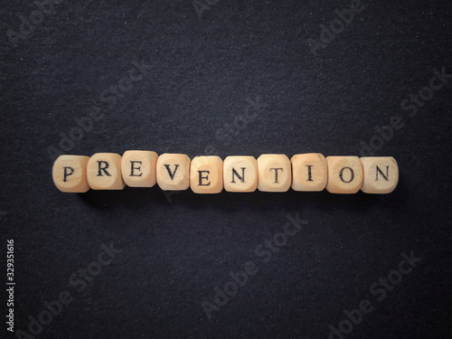 Health care and medical concept. PREVENTION written on wooden blocks. Blurred styled background. photo