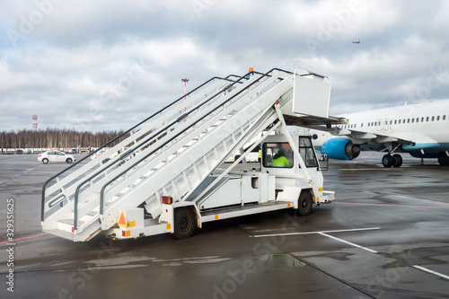 Passenger gangway next to aircraft at the airport.