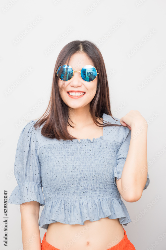 Fashion portrait of smiling beautiful women with sunglass posting on white background