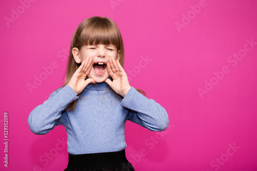 Closeup portrait of beautiful screaming little girl