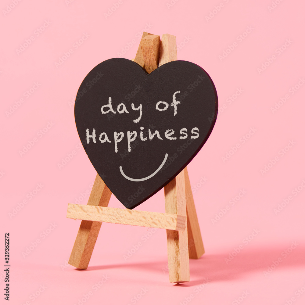 text day of happiness in a heart-shaped sign - obrazy, fototapety, plakaty 