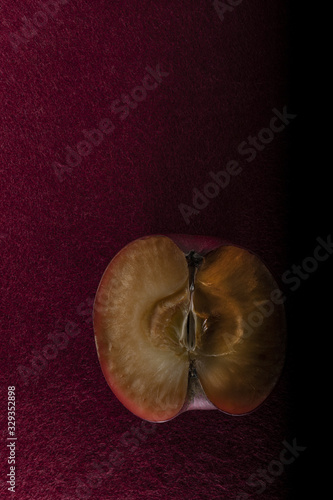 Dried Red Apple on red background cut in half