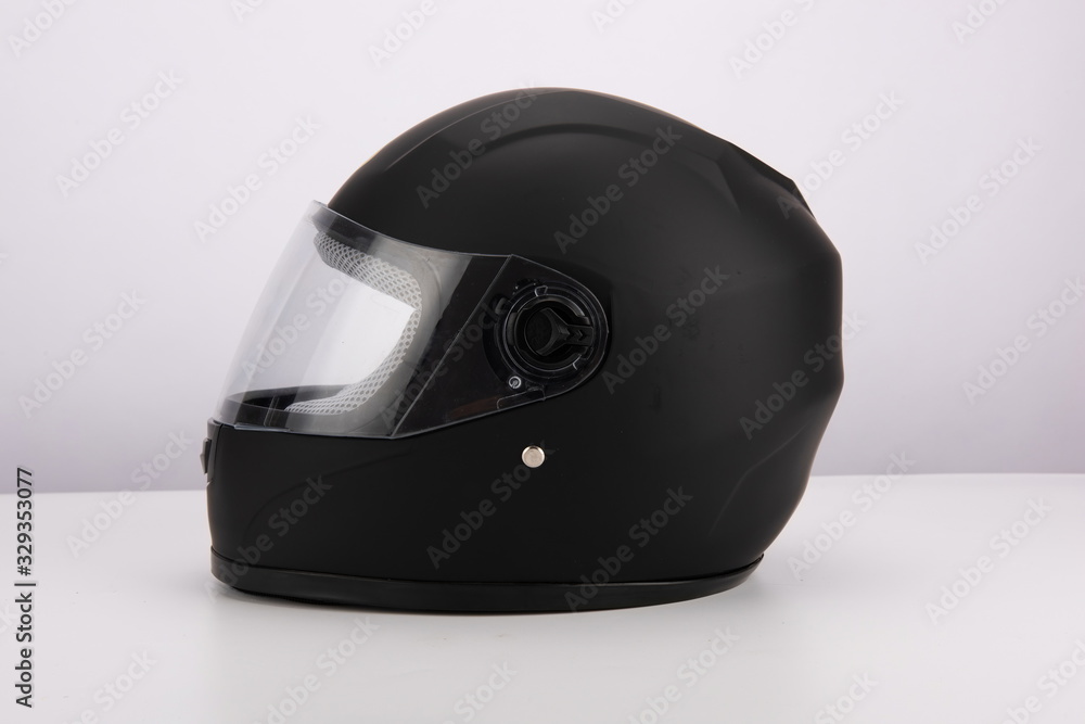 Black motorcycle helmet with wind shield and sun visor, classic helmet isolated on white background Black motorcycle helmet with wind shield and sun visor, classic helmet isolated on white background