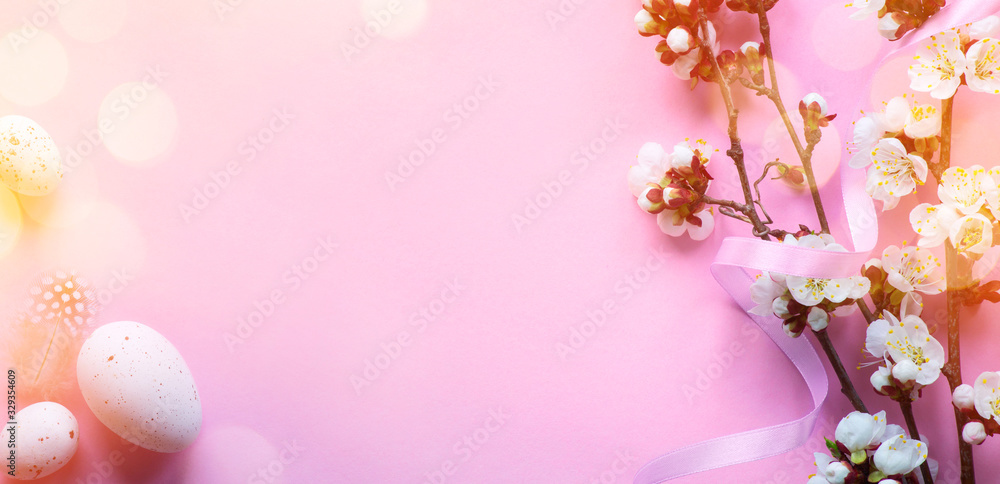 Art Easter banner with painted eggs and spring flowers on light pink background. Top view, flat lay with copy space. Art Easter banner with painted eggs and spring flowers on light pink background. Top view, flat lay with copy space.