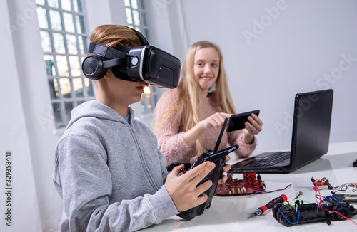 Kids exploring electricity, robotics and radio controlled toys, learning every day and trying out new things. Growing up, researching and inventing concept photo.