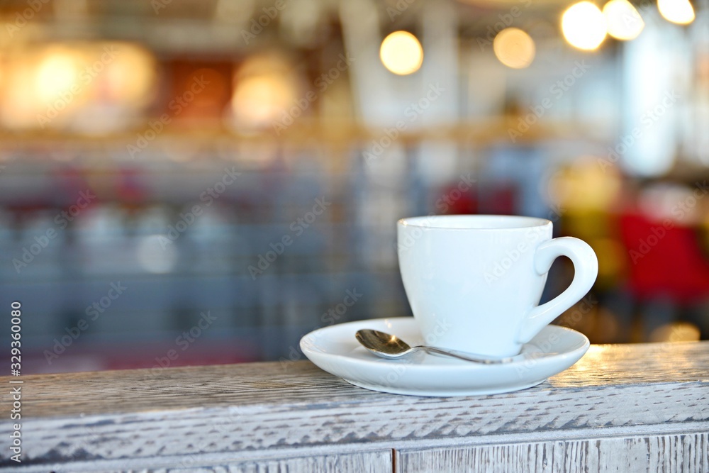Coffee cup in Prague cafe 2020. White mug with coffee on a white saucer. Hot coffee in a mug. Romantic background with cafe.