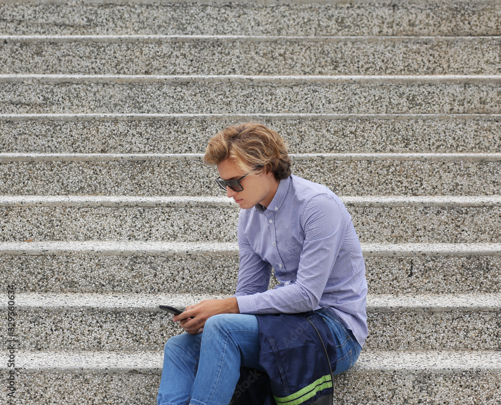Teenage boy typing text message.Using smart phone. Teenage boy typing text message.Using smart phone.