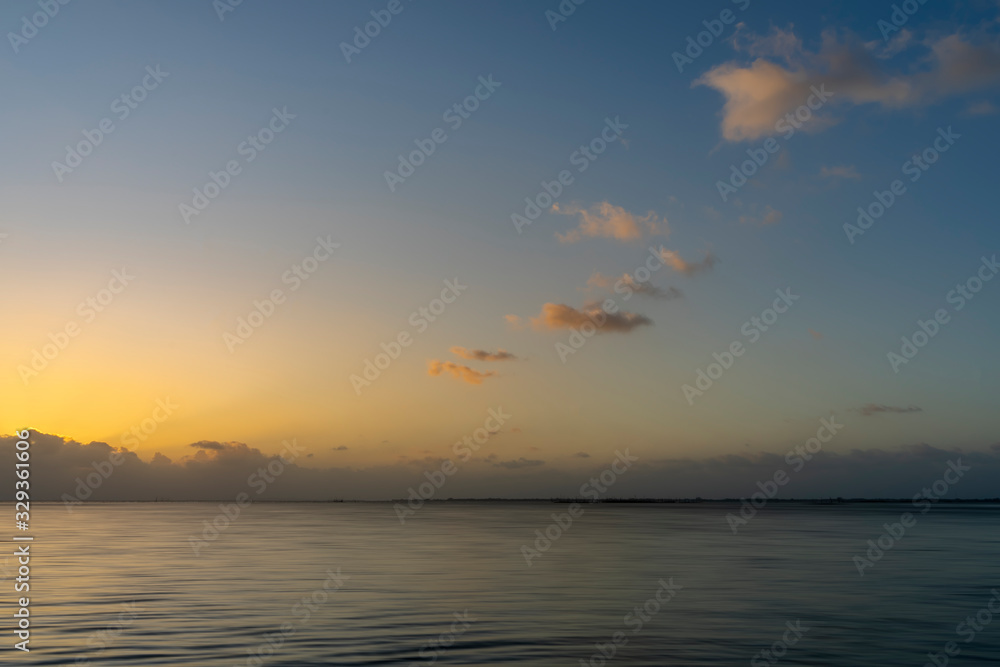 Sunset sky at the lake with clouds and motion fo the wave in golden hour. Sunset sky at the lake with clouds and motion fo the wave in golden hour.