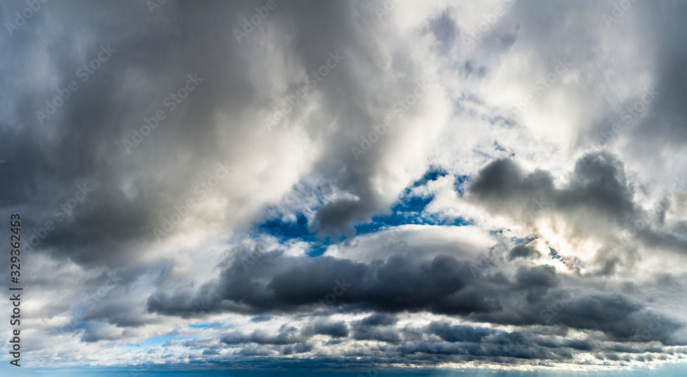 Obraz premium Fantastic dark thunderclouds at sunrise