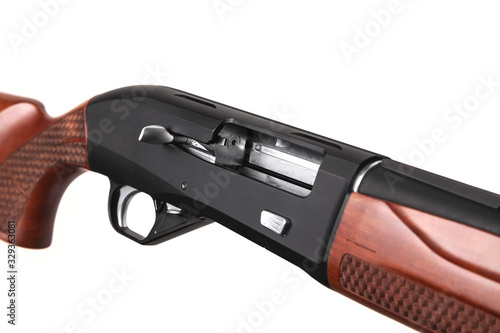 Modern semi-automatic shotgun with a wooden butt isolate on a white back. Weapons for hunting, sports and self-defense.