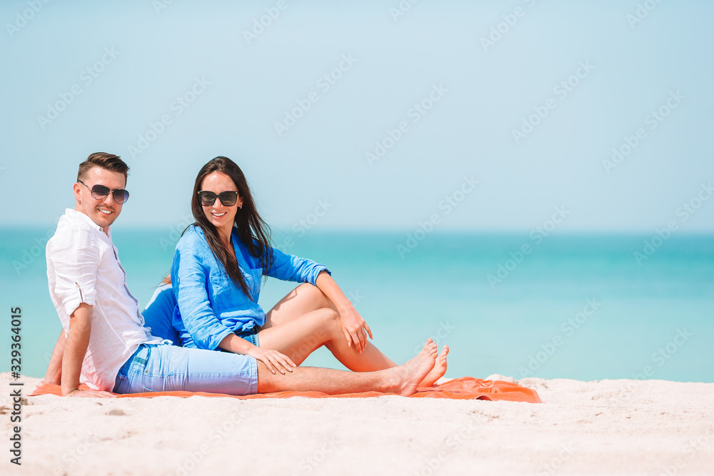 Young couple on white beach during summer vacation. Young couple on white beach during summer vacation.