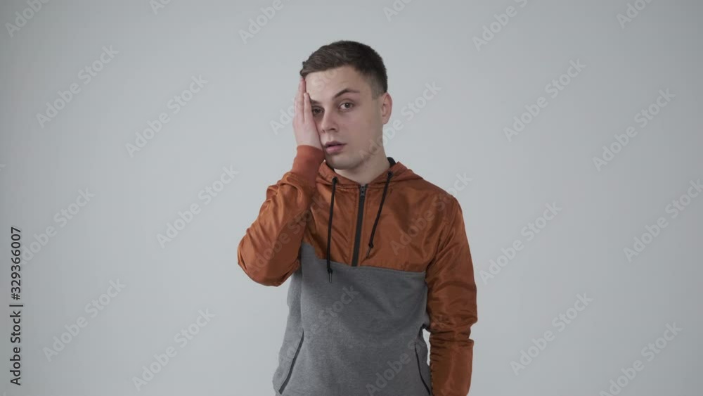 Man in hoodie regretting his misdeed over white background Man in hoodie regretting his misdeed over white background