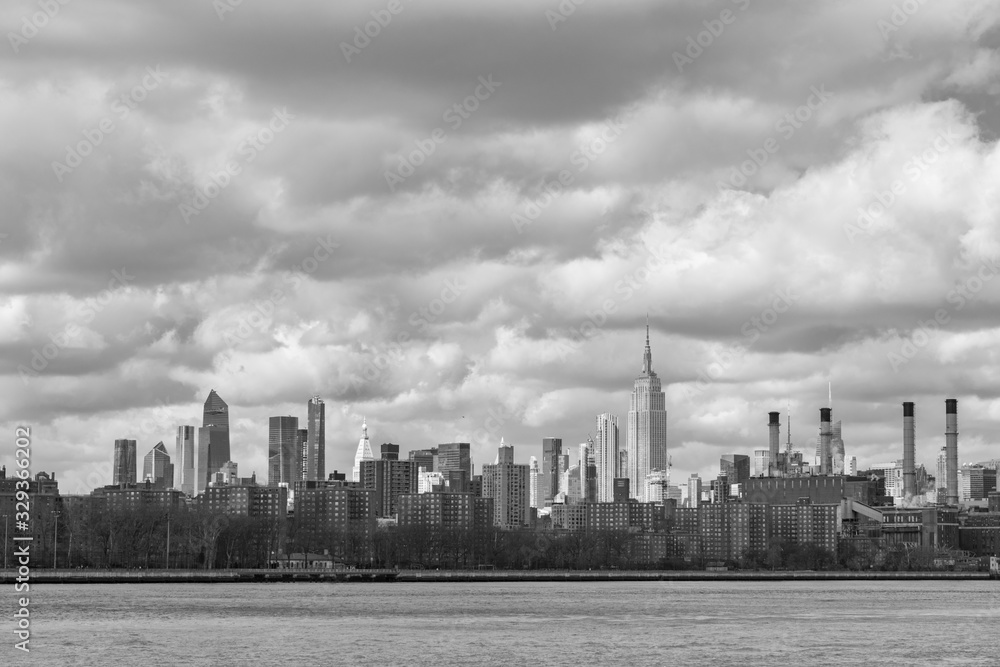 Black and White Midtown Manhattan Skyline with Clouds along the East River in New York City