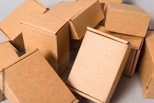 Set of brown cardboard mess boxes on grey background