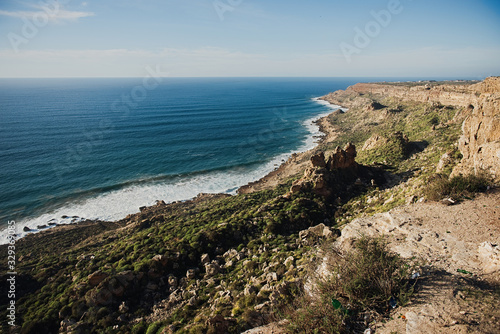 beautiful rugged coastline with waves crashing against the cliffs