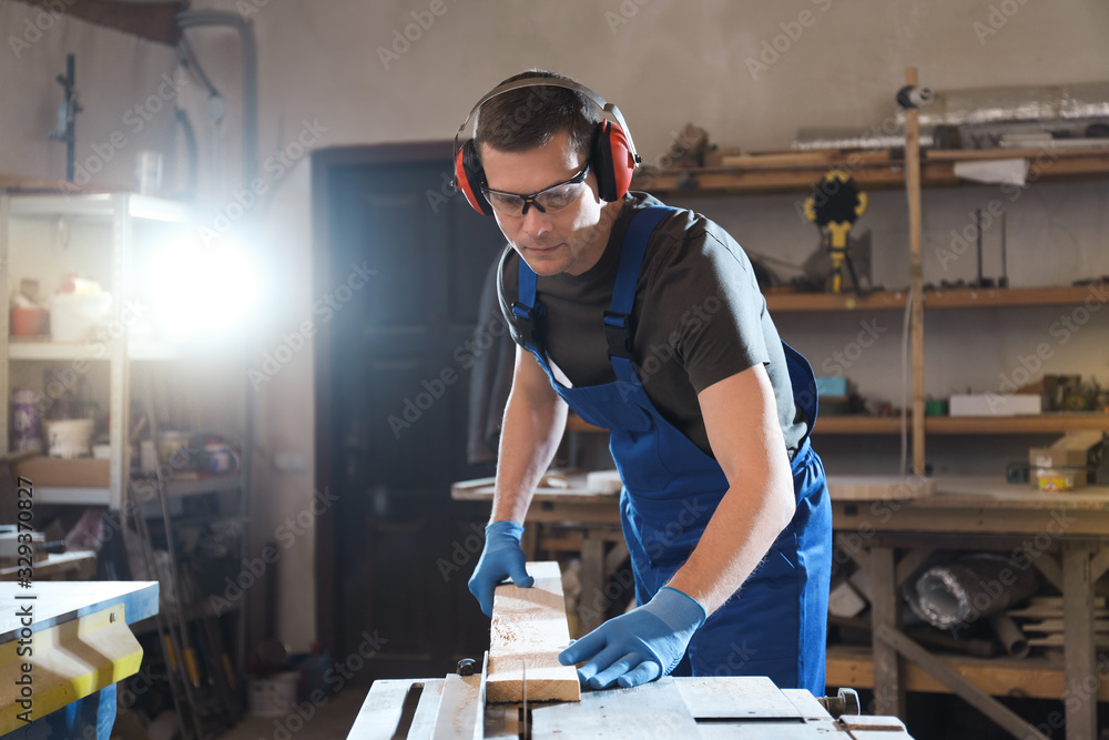 Professional carpenter working with wood in shop Professional carpenter working with wood in shop