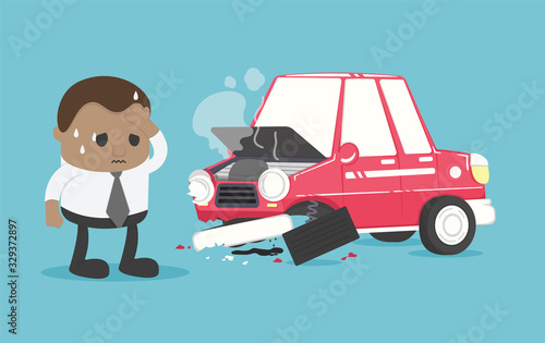 Young African businessman suffers from a car accident causing severe damage to his car.