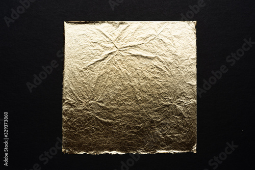 Textured gold leaf on a black background.